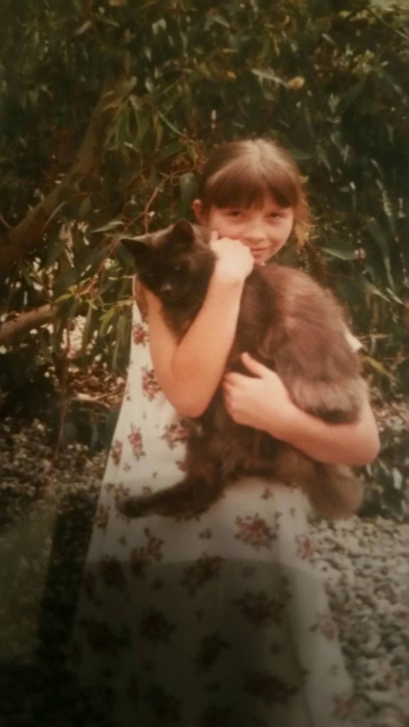 A person holds a cat.