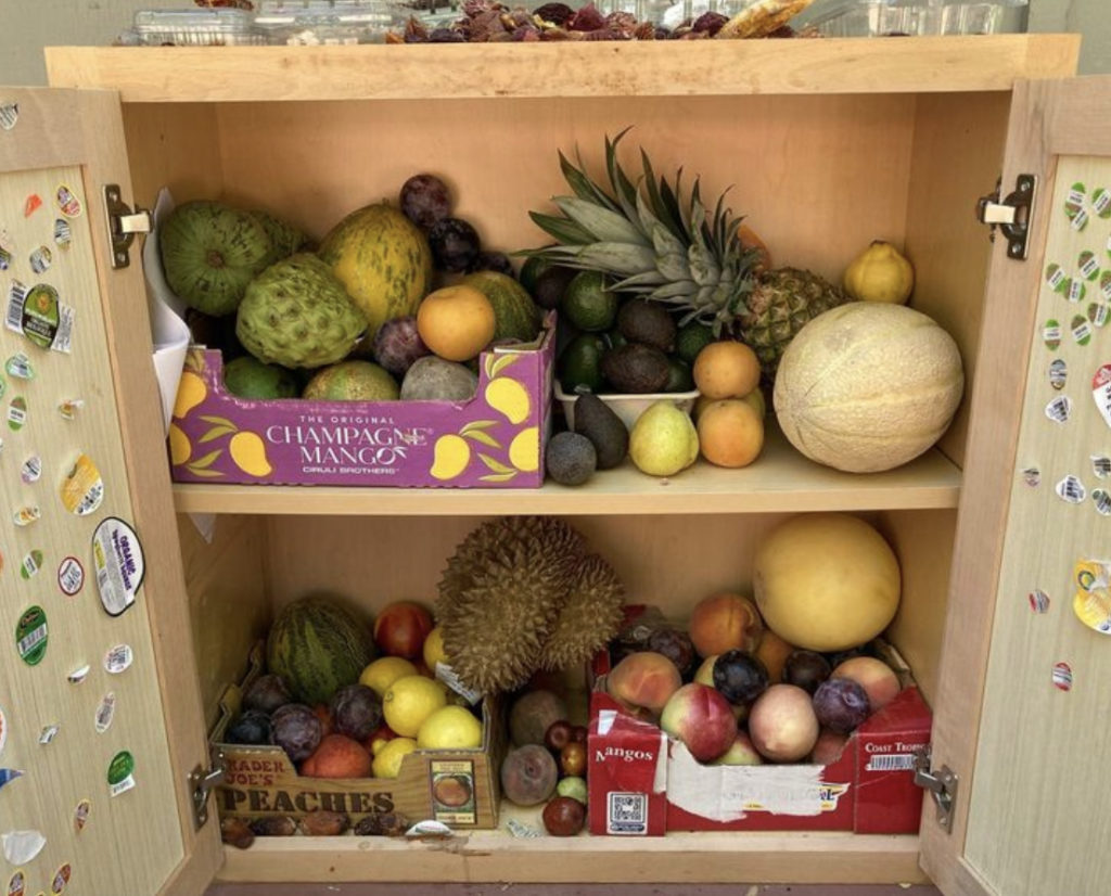 The shelf displays an array of fruits.