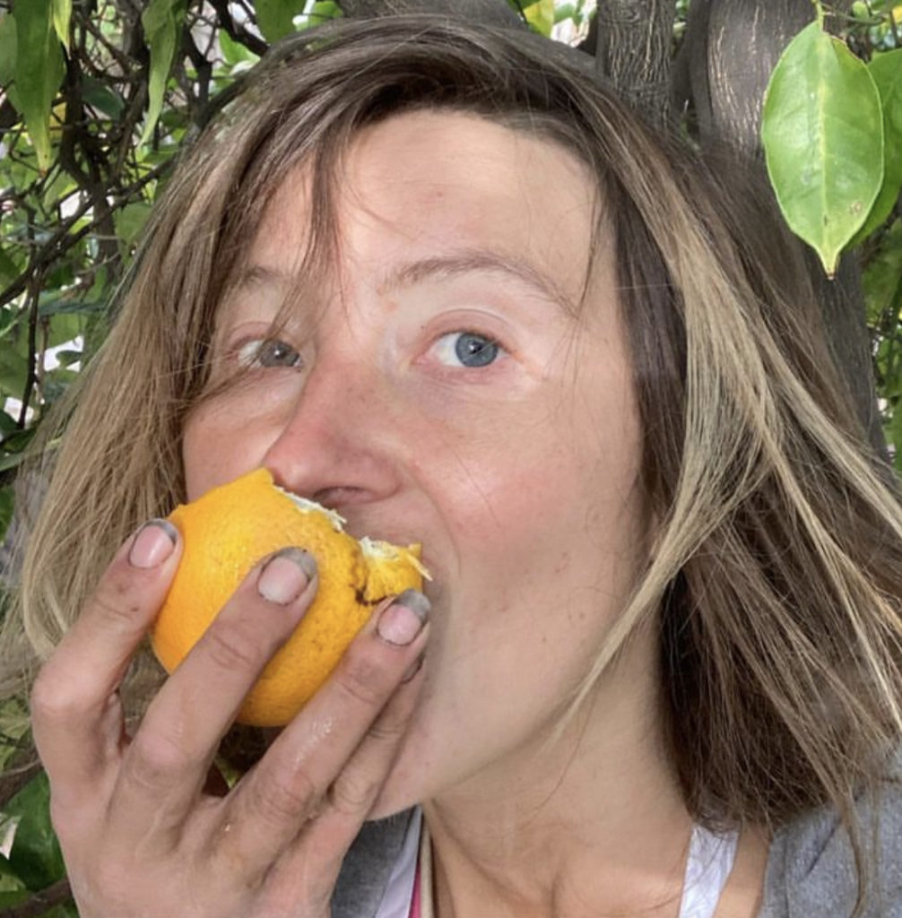 A person is consuming a fruit.