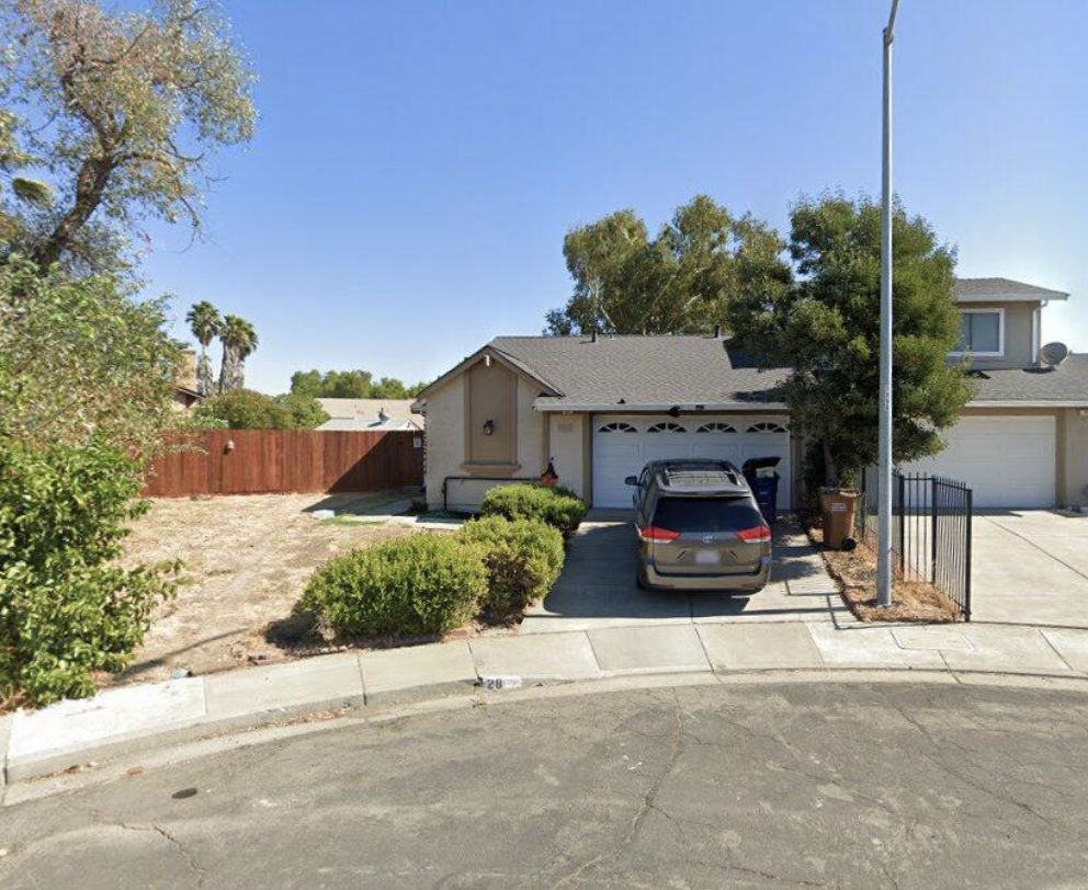 A car is parked in the driveway.